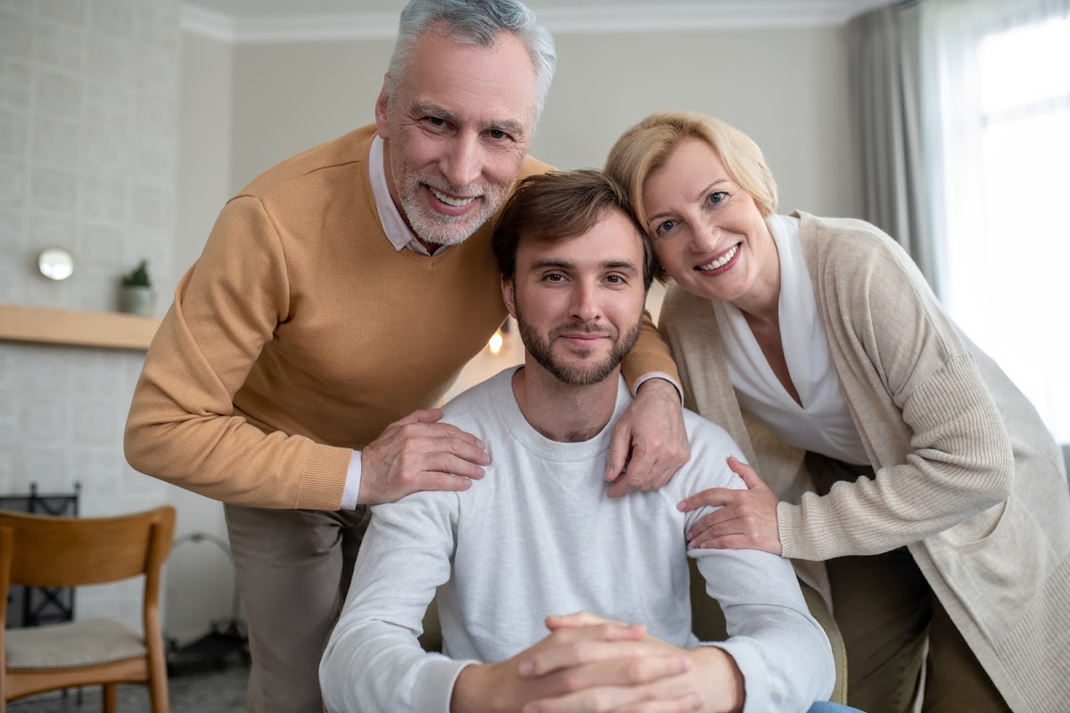 A supportive family surrounding a young man with disabilities, symbolizing the importance of legal guardianship for special needs individuals.