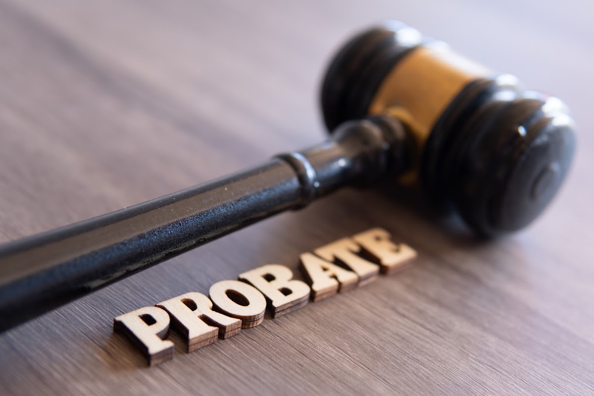 A judge’s gavel placed next to wooden letters spelling “PROBATE,” representing legal proceedings in estate matters.