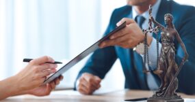 Businessman handing document for signature