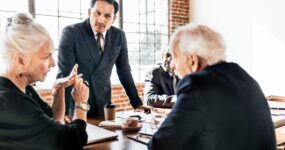 Businessman leading team meeting at office table