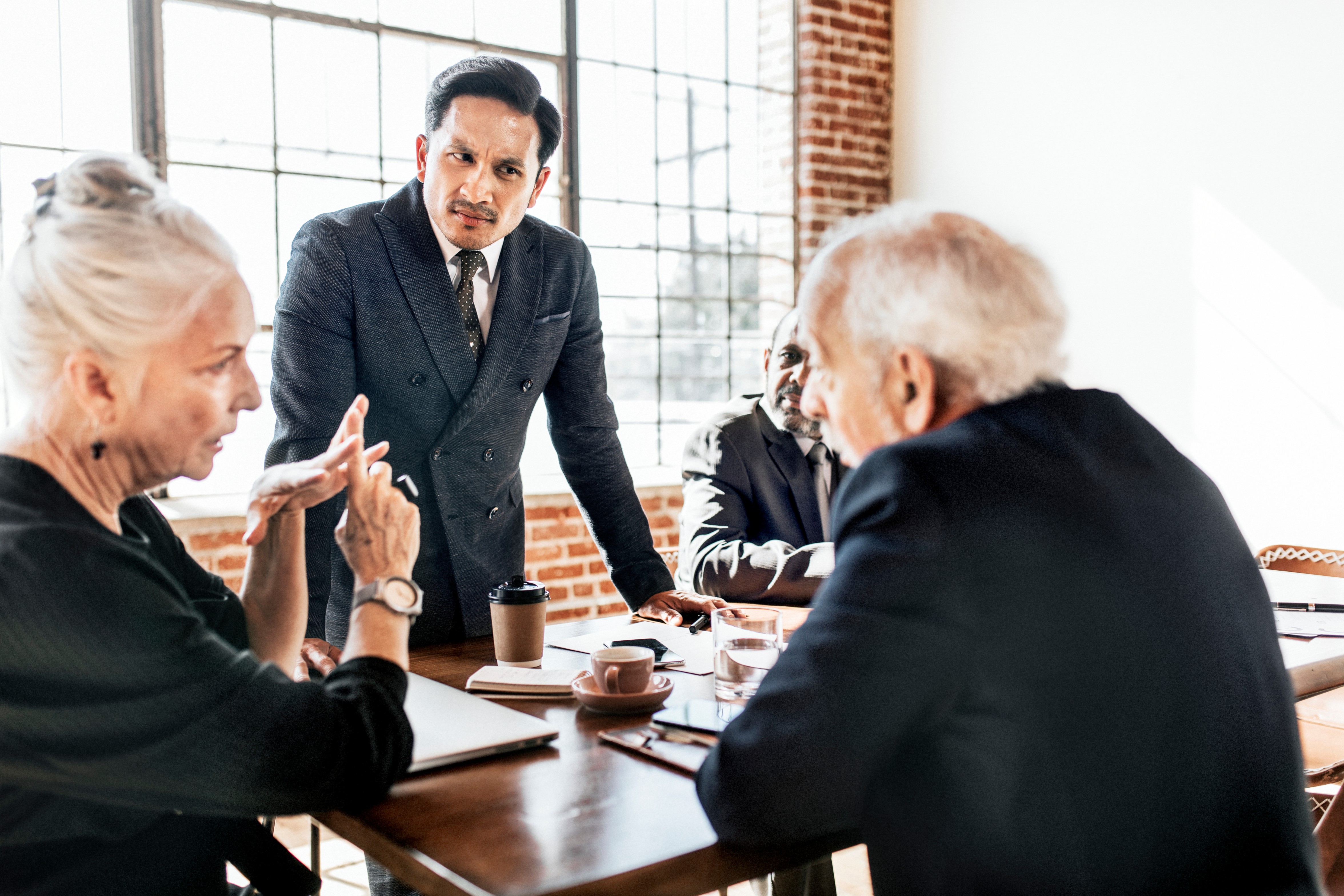 Businessman leading team meeting at office table